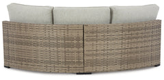 Calworth Outdoor Curved Loveseat with Cushion Ashley