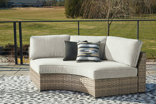 Calworth Outdoor Curved Loveseat with Cushion Ashley
